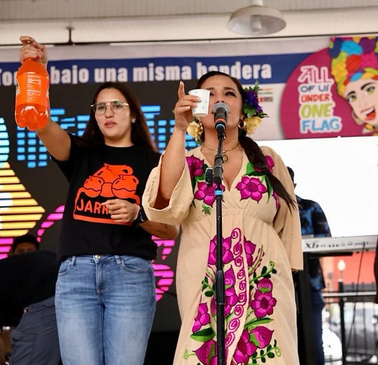 Jarritos Mandarin bottle and branded shirt during a stage presentation