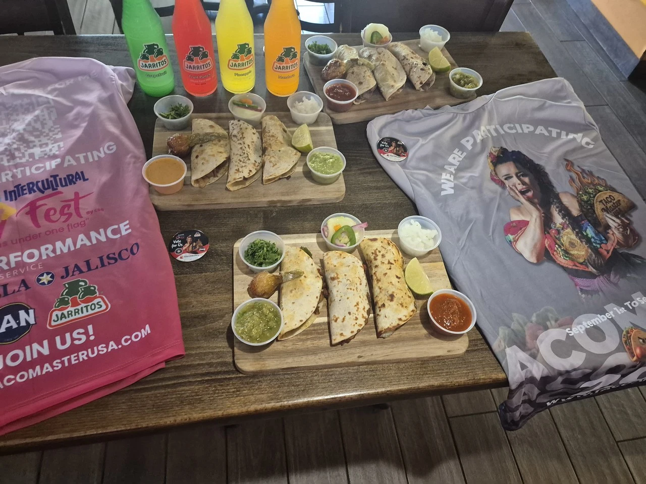 Four Jarritos bottles beside tacos and event apparel